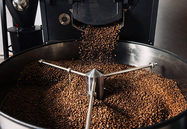 istock Roasted coffee beans are pouring from a machine in a manufacturer's 2252845100