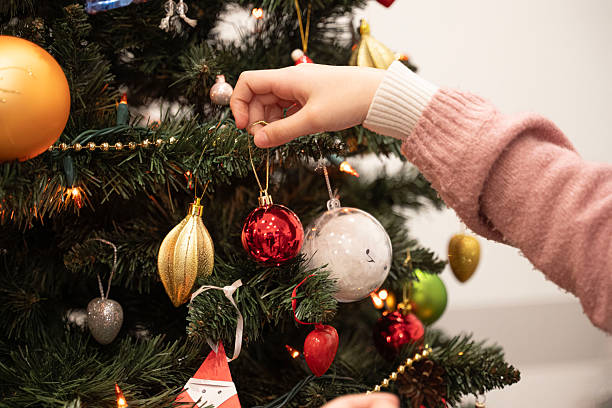 istock hanging a red Christmas ornament 2252847326