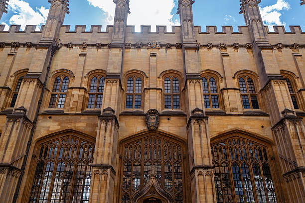 Detail of a Gothic-style college facade in Oxford, showcasing ornate stonework and medieval architectural elements. Oxford, United Kingdom, September 2025.