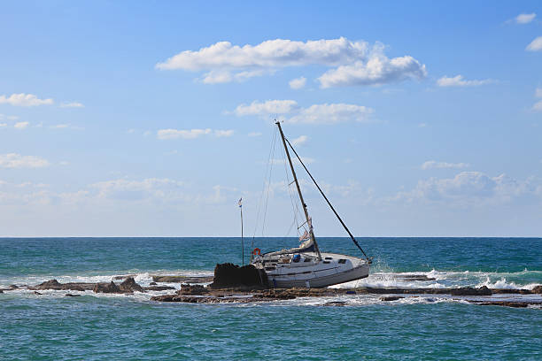 Aerial view of the cliff and the lagoon with the yacht.
