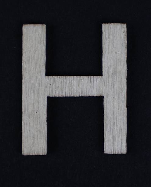H uppercase letter in woodgrain style. Part of a series, black background.