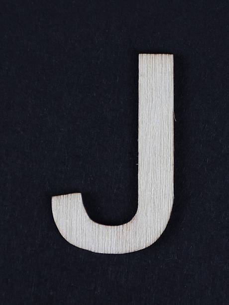 J uppercase letter in woodgrain style. Part of a series, black background.