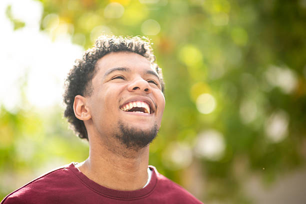 istock Smiling man looking up in outdoor setting with greenery 2252855560