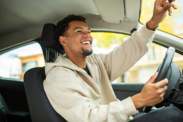 istock Man adjusting rear-view mirror in his car 2252856517