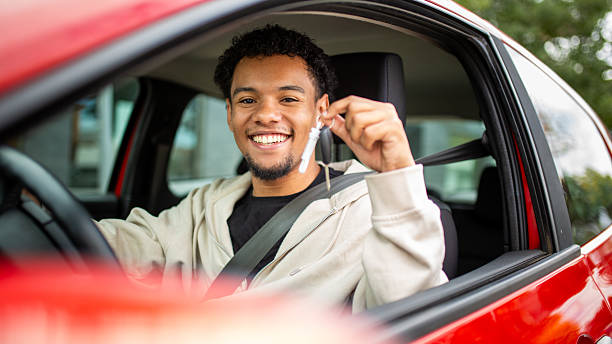 istock Smiling man with car keys in red car 2252856578