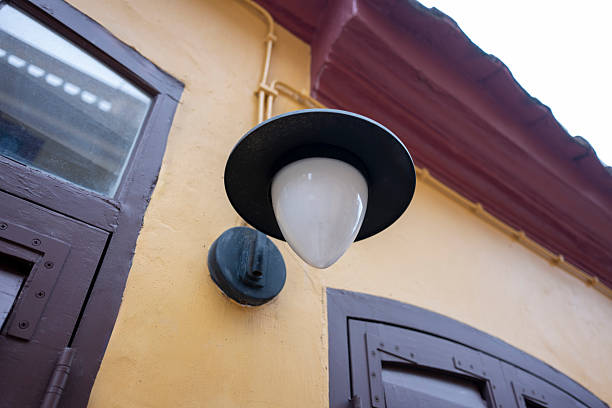 Vintage wall lamp on the yellow wall