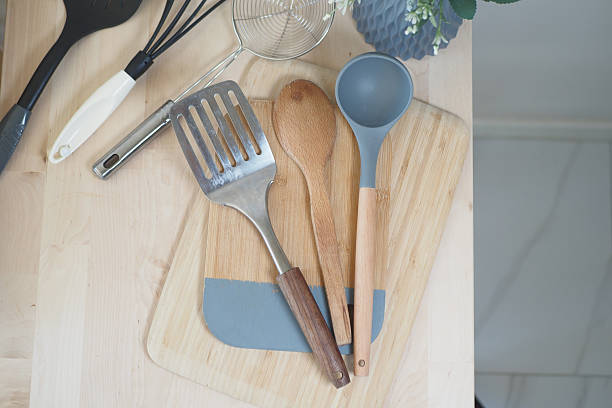 istock Cooking utensils arranged on wooden cutting board 2252861667