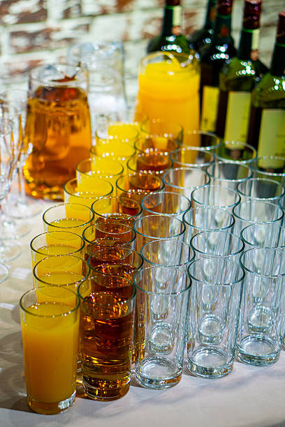 istock Rows of fresh fruit juices and empty glasses served at a professional event buffet. 2252861952