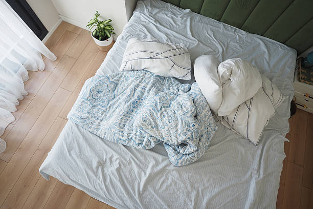 istock messy bed in a bedroom at early morning 2252863713