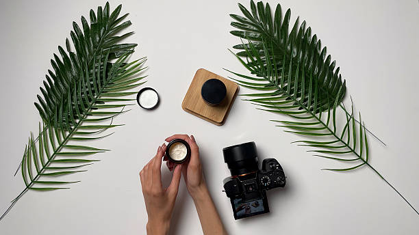 istock Hands are preparing skincare items and a camera is placed nearby on a white surface 2252863951