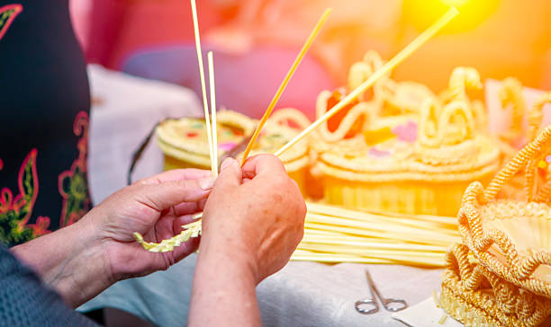 A skilled artisan carefully weaves natural materials into unique baskets, showcasing traditional crafting techniques in a lively workshop.