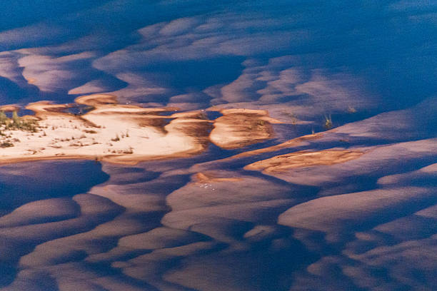 An aerial view of the Zambezi river, with beautiful sunlight reflected and highlightin the shallow sand banks, just before plunging off the mighty Victoria Falls.