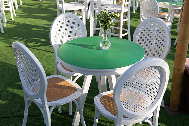 Orange plastic chairs with furniture at the seaside terrace with sky on background