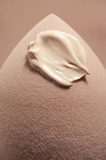 Egg shaped make-up beige sponge with swatch of foundation bb cc cream