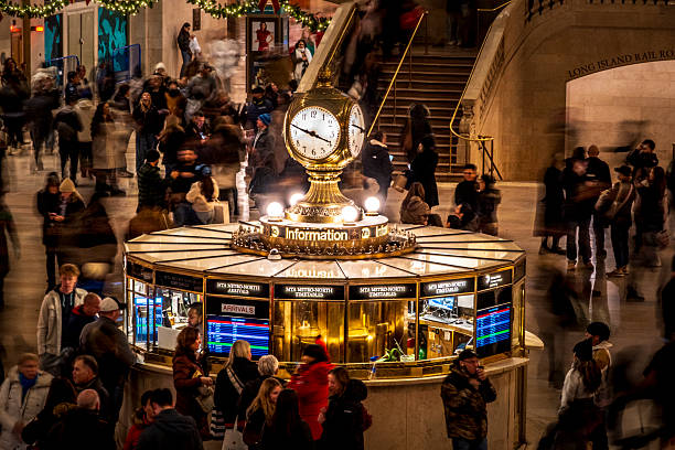 Doors to main hall of Grand Central Terminal with clock above. Long historical message above