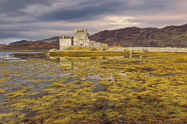 Dornie, Scotland-October 23, 2022: Eilean Donan island and its medieval castle, originated in the XIII century and reconstructed and connected to the mainland by a footbridge in the early XX century.
