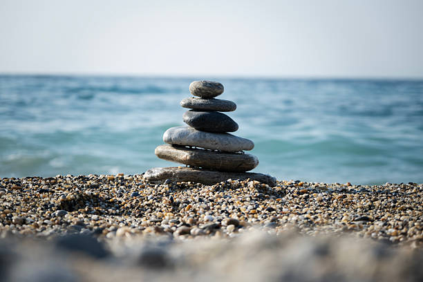 istock Zen balancing stones carefully stacked on a pebble beach, symbolizing harmony, peace, and mindfulness by the calming ocean, creating a serene and tranquil scene 2252878384