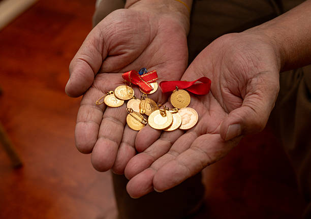 istock Man with gold coins in the hand 2252885484