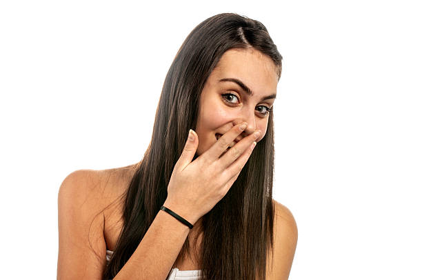 Portrait Of Girl With Mouth Open Gesturing While Standing Against White Background