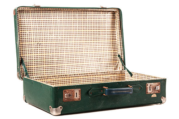 Summer holidays are here: An open suitcase on the bed near the window. Getting ready for a trip.
