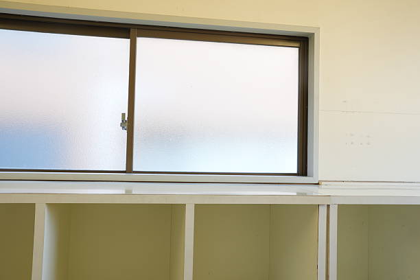 istock A window with a white blinds and a wooden cabinet 2252894321