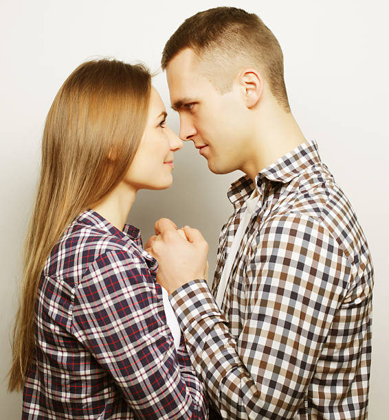 istock lovely happy couple hugging over grey background. 2252896879