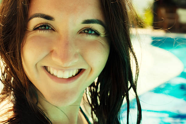 Portrait of a young woman smiling in a swimming pool