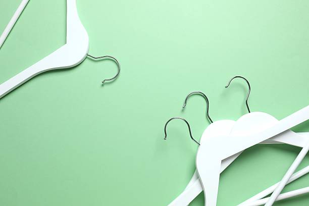 istock Wooden clothes hangers on a colored background 2252901190