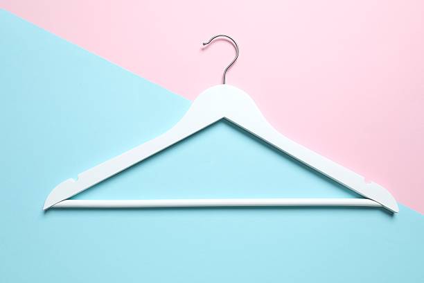 istock Wooden clothes hanger on a colored background 2252901225
