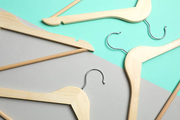 istock Wooden clothes hangers on a colored background 2252901246