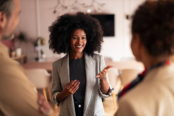 istock Confident Woman Leads Friendly Office Discussion With Colleagues In Modern Workspace 2252901765