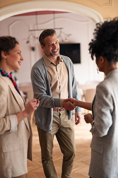 istock Friendly Handshake Among Colleagues During Casual Office Meet-Up And Warm Conversation 2252901788