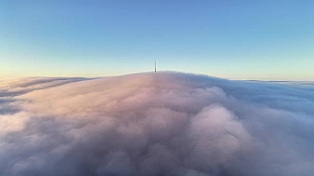 istock Quiet Dawn Overlooking Cloudshrouded Mountain Crest Adorned With Broadcasting Antennas And Guiding Beacon 2252903245