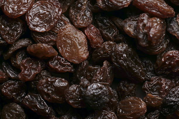 istock Black raisins close up studio shot over 2252903812
