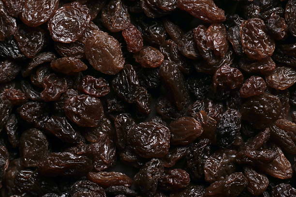 istock Black raisins close up studio shot over 2252903815