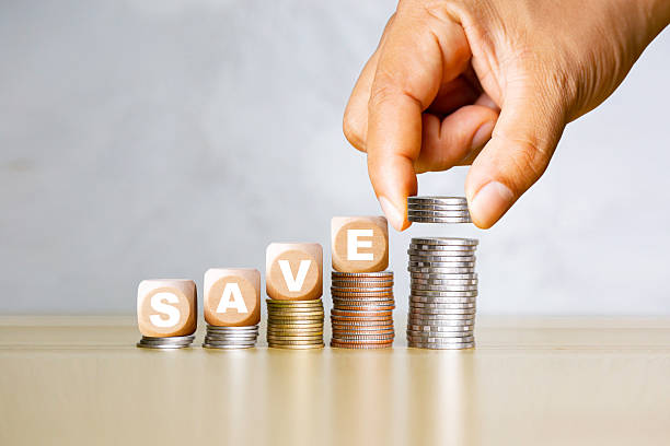 istock Saving money concept with stacked coins and blocks spelling SAVE, symbolizing financial growth, investment, and smart money management. 2252904504