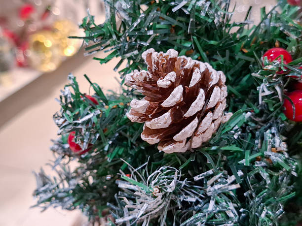 istock Close up of natural brown pinecone on artificial evergreen spruce branches with winter berries for Christmas holiday season home interior decoration and festive celebration background 2252906441