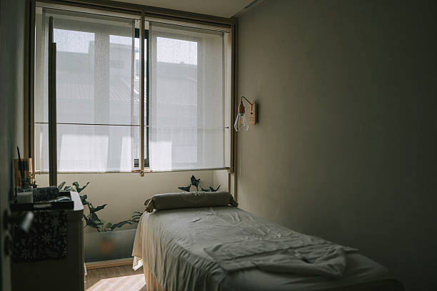 istock Minimalist massage therapy room interior with empty treatment bed and copy space 2252910950