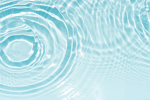 istock Bluewater waves on the surface ripples blurred. Defocus blurred transparent blue colored clear calm water surface texture with splash and bubbles. Water waves with shining pattern texture background. 2252912803