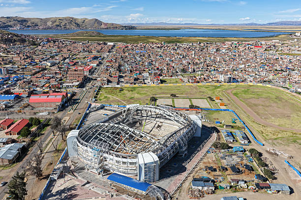 Aerial view of a coliseum with a metal structure roof under construction