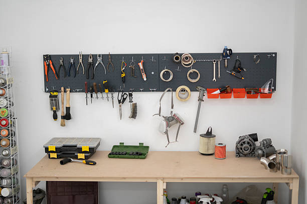 A well-organized workspace in a car service setting showcases various tools and equipment mounted on a pegboard, ideal for vehicle maintenance and repairs.