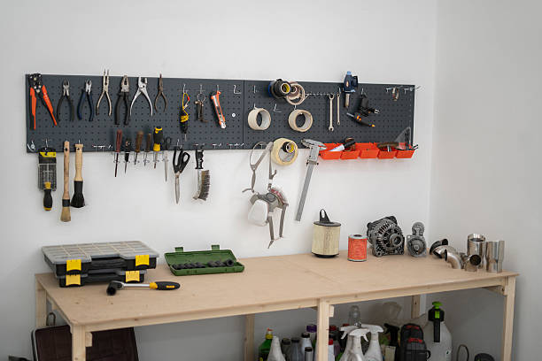 A well-organized workspace in a car service setting showcases various tools and equipment mounted on a pegboard, ideal for vehicle maintenance and repairs.