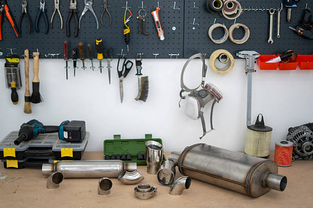 istock Exhaust system parts are arranged on a workbench, displaying various components for service, including mufflers and exhaust tips 2252914780