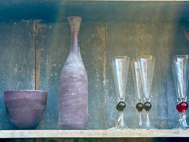 Vases and glasses on  a rustic blue wooden shelf
