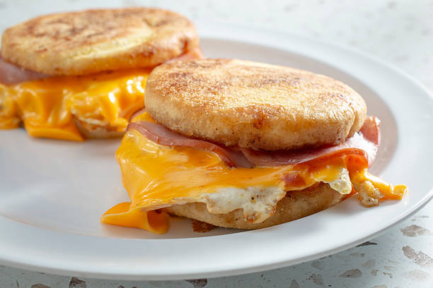 A view of some breakfast sandwich, featuring English muffins.