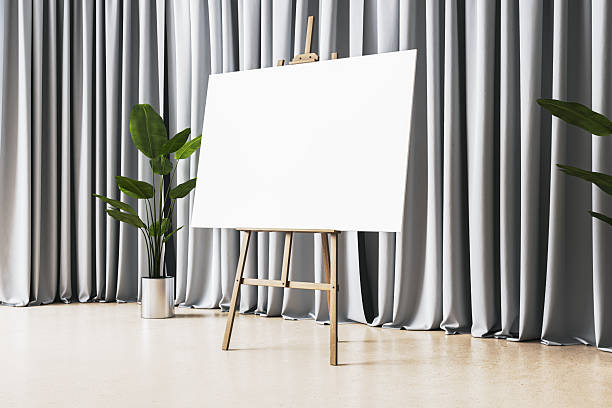 Blank canvas on a wooden easel placed in a clean modern room with shiny floor, potted plants, and gray curtains. Concept of art or presentation. 3D Rendering