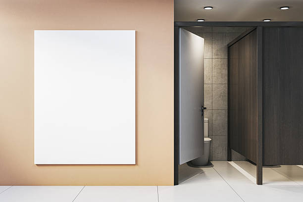 istock Vertical blank poster mockup on beige wall next to modern restroom interior with open stall door and tiled walls for advertising display. 3D Rendering 2252925893