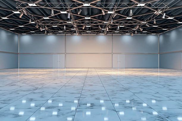 istock Spacious modern exhibition showroom interior with marble floor, industrial ceiling lighting, and empty open room view from the front perspective. 3D Rendering 2252925963