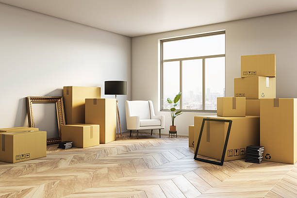 istock Modern interior room with moving boxes, chair, lamp, frames, plant and city view through window in bright empty space. 3D Rendering. 3D Rendering 2252926009