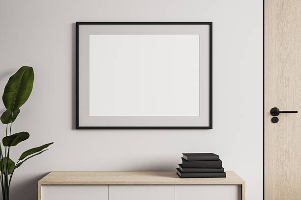 istock Horizontal blank poster frame mockup on white wall in modern interior room with cabinet, books, plant and wooden door, front view scene. 3D Rendering 2252926017